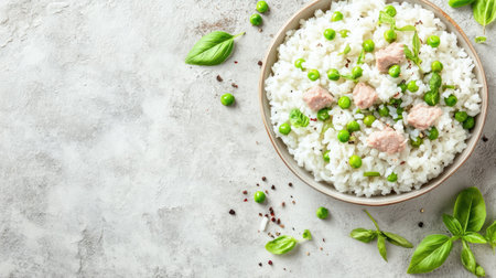 Healthy baby meal with soft rice, finely chopped meat, and peas, surrounded by copy spaceの素材
