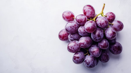 Delicious grapes in a bunch on a white surface, ideal for adding textの素材