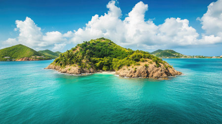 Pristine island surrounded by calm, emerald-green waters under a bright blue sky, copy space providedの素材