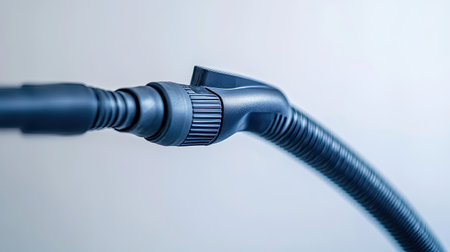 A detailed close-up image showcasing the connector of a modern vacuum cleaner hose, emphasizing the sleek design and innovative features of home cleaning technology.の素材