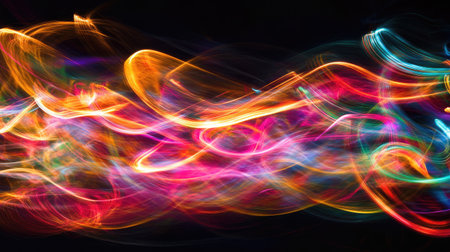 This image showcases vibrant and colorful light trails creating mesmerizing abstract motion patterns against a dark background. Perfect for artistic designs.の素材