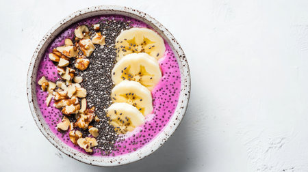 Delight in a vibrant smoothie bowl topped with banana slices, chia seeds, and nuts. Perfect for breakfast or a healthy snack, showcasing freshness and taste.の素材