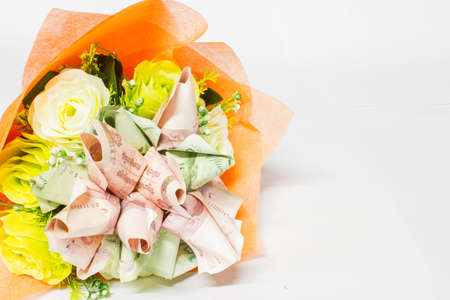 Bouquet of flowers made from currency bahtの写真素材