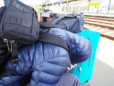 tourists or the homeless man is waiting for the train in the cold weatherの写真素材