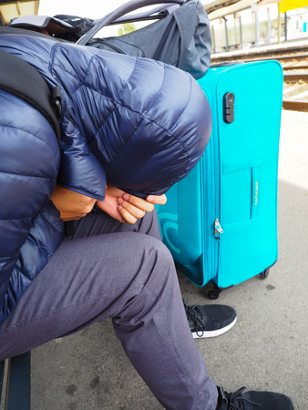 tourists or the homeless man is waiting for the train in the cold weatherの写真素材