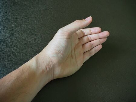 The man's hand on the black backgroundの写真素材