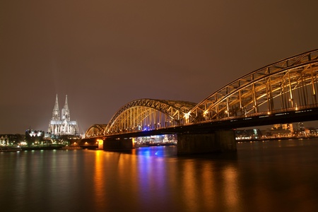 Cologne cathedral with Hohenzollern bridge at nightの写真素材