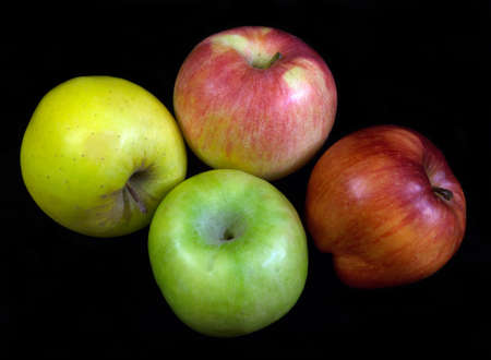Various apples isolated over black の写真素材