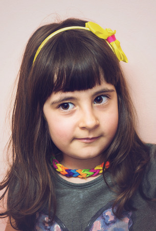 Cute child girl portrait at home in soft tonesの写真素材