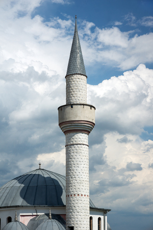Mosque tower on dramatic clouds backgroundの写真素材