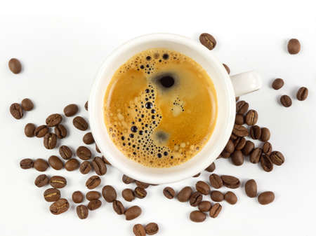 A cup of coffee and coffee beans on white backgroundの写真素材