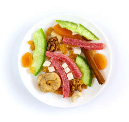 Dried fruits and nuts in white plate on white backgroundの写真素材