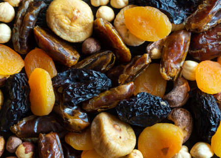 Dried fruits and nuts on old wooden table