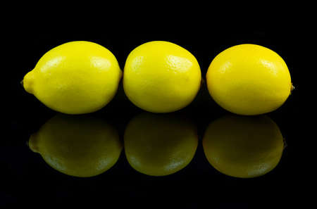 Lemons on reflective black studio backgroundの写真素材