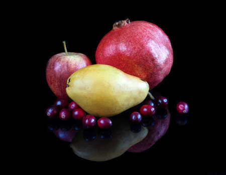 Fruits on reflective black studio backgroundの写真素材