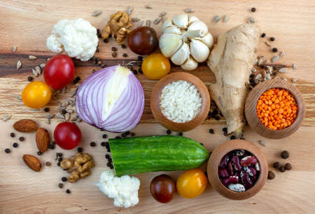 Set of different spices and vegetables on wooden boardの写真素材