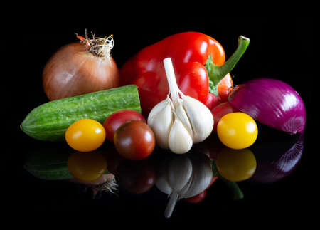 Different vegetables on reflective black backgroundの写真素材