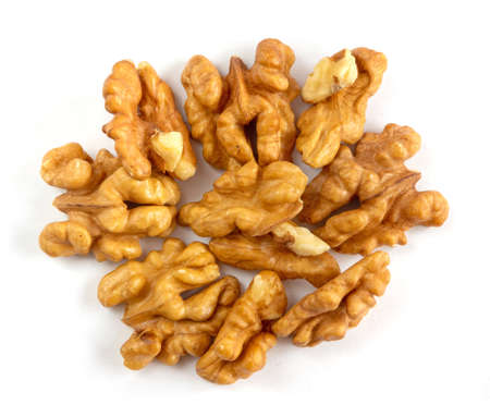 Cracked walnuts cores on white backgroundの写真素材