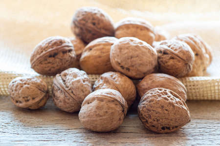 Walnuts over wooden boardの写真素材