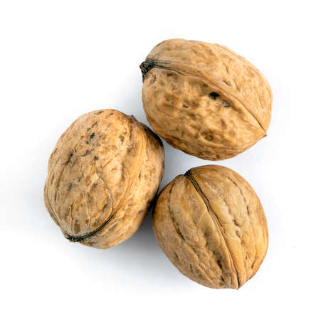 Whole solid walnuts on white backgroundの写真素材