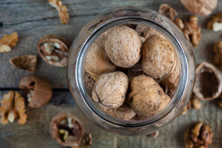 Whole solid walnuts in a jar top viewの写真素材