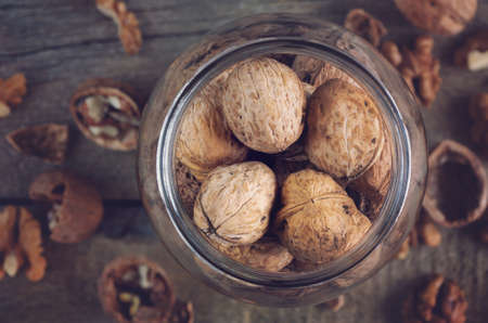 Whole solid walnuts in a jar top viewの写真素材