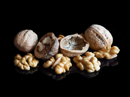 Walnuts on black reflective backgroundの写真素材