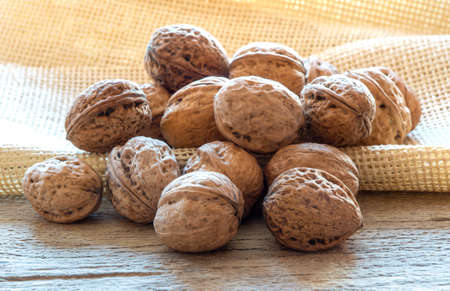 Walnuts over wooden boardの写真素材