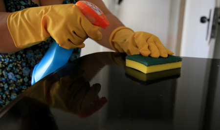 salvador, bahia / brazil - may 14, 2020: person is seen wearing rubber gloves while cleaning furniture at home. *** Local Caption ***.のeditorial素材