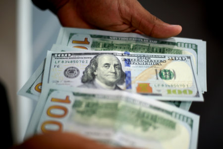 salvador, bahia / brazil - february 11, 2015: Hands hold dollar banknotes in currency exchange. *** Local Caption ***のeditorial素材