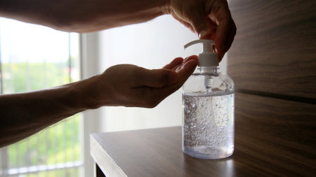 salvador, bahia / brazil - may 12, 2020: person is seen using alcohol gel hand hygiene to protect against Corona Virus. *** Local Caption ***のeditorial素材
