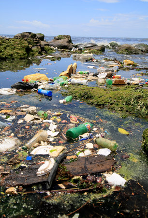 salvador, bahia, brazil - january 11, 2021: pollution and garbage on the Costa Azul beach in the city of Salvador. The material is drained into the sewage channel of the Rio Camurugipe and dumped into the sea.のeditorial素材