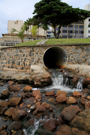 salvador, bahia, brazil - january 15, 2021: pipe is seen pouring rainwater and sewage on Ondina beach in the city of Salvador.のeditorial素材