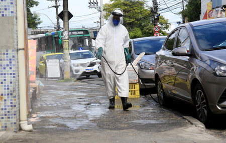 salvador, bahia, brazil - january 27, 2021: cleaning agent performs street disinfection against the corona virus in the Liberdade neighborhood in the city of Salvador.のeditorial素材