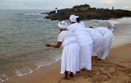 salvador, bahia, brazil - february 2, 2021: members of the Candomble religion are seen during an offering delivery to the orisha Yemanja on the Rio Vermelho beach in the city of Salvador.のeditorial素材
