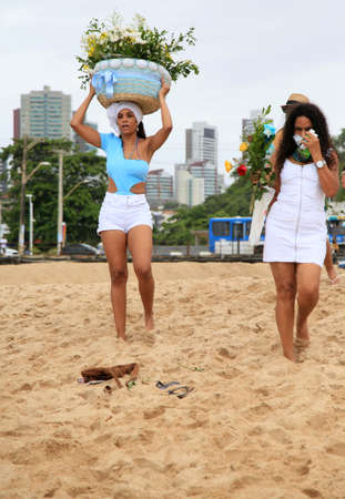 salvador, bahia, brazil - february 2, 2021: members of the Candomble religion are seen during an offering delivery to the orisha Yemanja on the Rio Vermelho beach in the city of Salvador.のeditorial素材