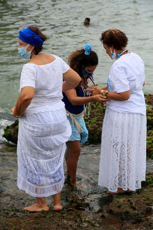 salvador, bahia, brazil - february 2, 2021: members of the Candomble religion are seen during an offering delivery to the orisha Yemanja on the Rio Vermelho beach in the city of Salvador.のeditorial素材