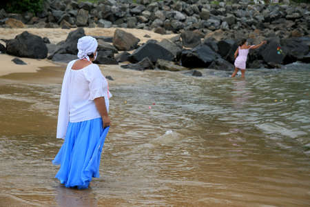 salvador, bahia, brazil - february 2, 2021: members of the Candomble religion are seen during an offering delivery to the orisha Yemanja on the Rio Vermelho beach in the city of Salvador.のeditorial素材