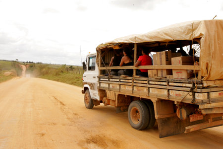 itamaraju, bahia brazil - september 23, 2010: people are seen in a truck body on a dirt road in the countryside of the city of Itamarajuのeditorial素材