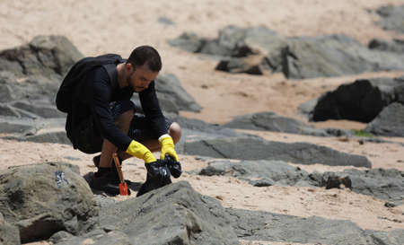 salvador, bahia / brazil - October 13, 2019: Volunteers clean up oil at Jardim de Alah Beach, the site was affected by oil spills at sea.のeditorial素材