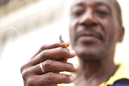 salvador, bahia / brazil - march 15, 2017: Man is seen smoking cigarette in the city of Salvador.