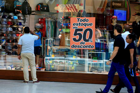 salvador, bahia / brazil - october 21, 2015: poster announcing a 50% discount in a store window in the city of Salvador.のeditorial素材