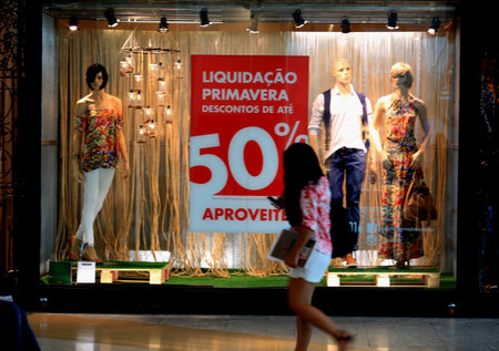 salvador, bahia / brazil - october 21, 2015: poster announcing a 50% discount in a store window in the city of Salvador.のeditorial素材