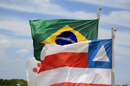 salvador, bahia, brazil - december 23, 2020: flag of brazil and the state of Bahia are seen on a mast at the airport of the city of Salvador.の写真素材