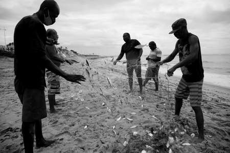 salvador, bahia, brazil - december 18, 2020: fishermen are seen during fishing with a trawl along the fishing colony on Pituba beach, in the city of Salvador.のeditorial素材