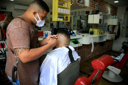 salvador, bahia, brazil - december 9, 2020: barber is seen working in a barber shop in the city of...