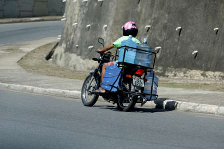 salvador, bahia / brazil - april 6, 2017: delivery of mineral water on a motorcycle, seen on Avenida...