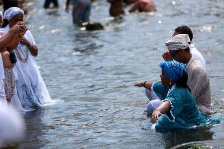 salvador, bahia / brazil - february 2, 2015: supporters of candomble are seen on the Rio Vermelho beach in the city of Salvador during a party in honor of Yemanja.のeditorial素材