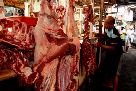 salvador, bahia / brazil - may 11, 2013: a person is seen joining the bolvina meat for sale in a...