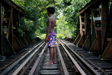 mata de sao joao, bahia / brazil - november 9, 2020: young man is seen near a railroad bridge in the city of Mata de Sao Joao.のeditorial素材